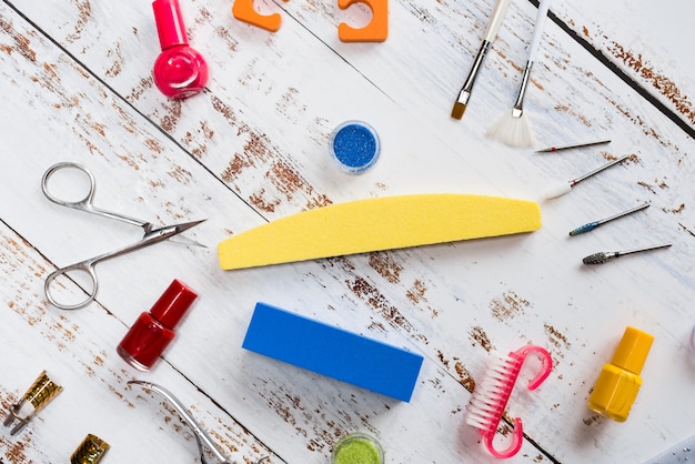 Manicure tools, sequins, nail polishes. the view from the top