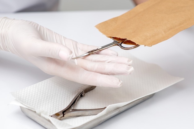 Manicurist hands taking manicure tools