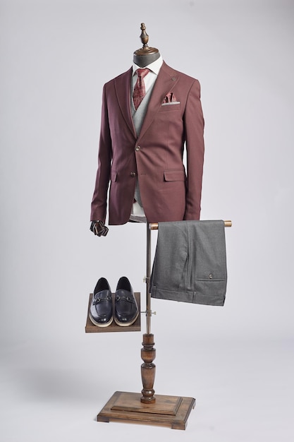 A mannequin with a suit and shoes on it