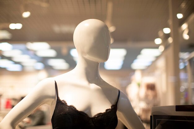 Mannequin of a woman in a bra in a shop window