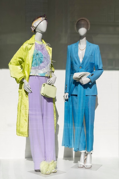 Mannequins in the window of a fashion boutique New women's summer collection Style and elegance Vertical