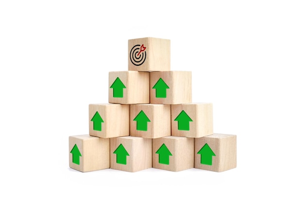 manpower to target or goal concept wood cube block pyramid with dartboard icon and up arrow icon