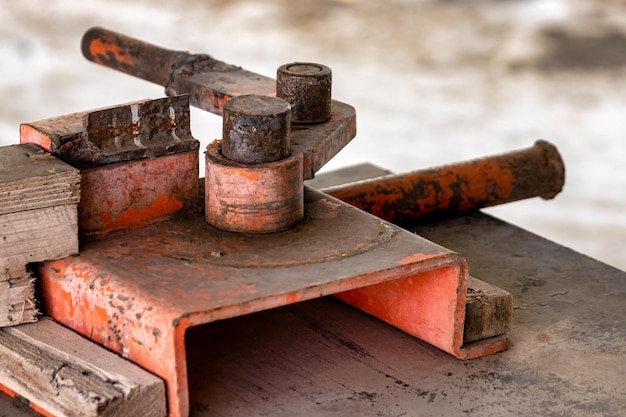 Manual machine for bending reinforcement Closeup Reinforcement bending in construction conditions Mechanism for bending steel rods