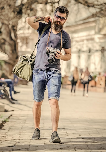 Manual settings Photographer with beard and mustache Tourist shooting photos Content creator Man bearded hipster photographer Old but still good Photographer hold vintage camera Modern blogger