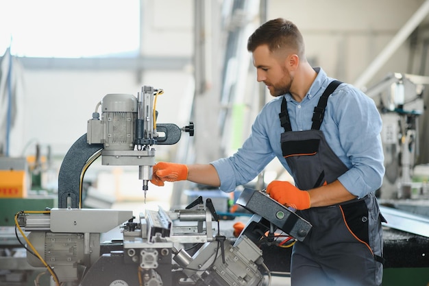 Manual worker cutting aluminum and PVC profiles Manufacturing jobs Selective focus Factory for aluminum and PVC windows and doors production