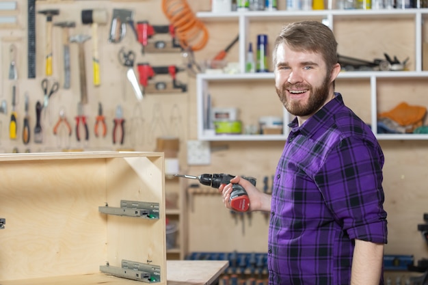 Manufacturing, Small-Sized Companies and worker concept - man working on the furniture factory.