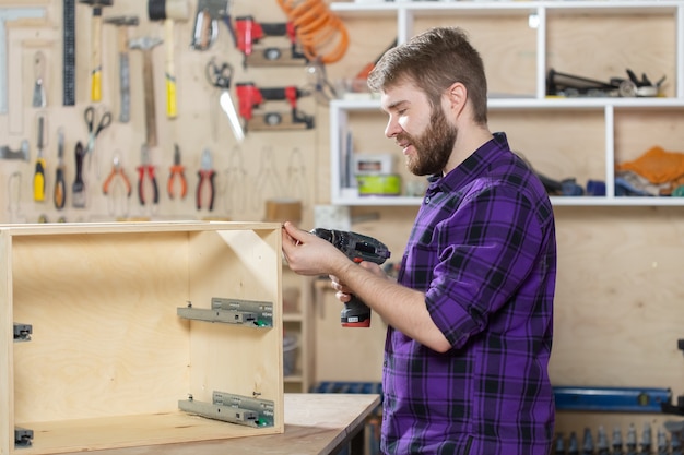 Manufacturing, Small-Sized Companies and worker concept - man working on the furniture factory.