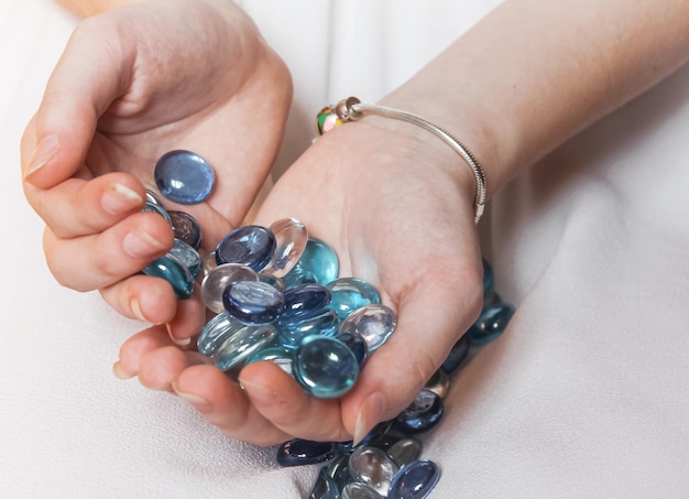 Many beautiful beads in the hands of a girl