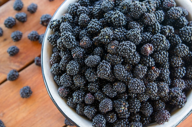 Many blackberries in a metal bowl