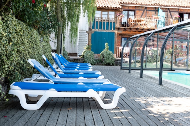 Many blue lounge chairs beside the pool