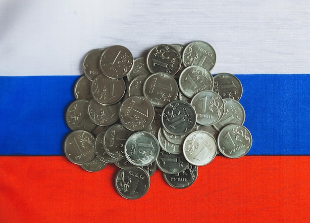 Many coins of 1 ruble lie on Russian money