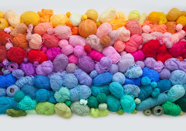 Many colorful balls of wool and cotton yarns