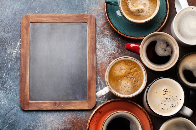 Many cups of coffee on stone table