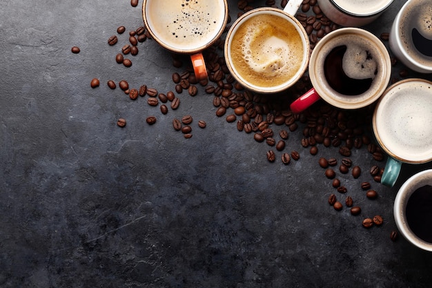 Many cups of coffee on stone table