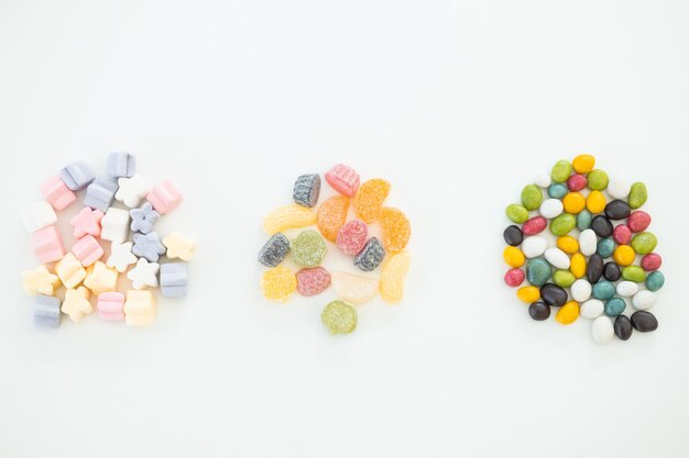 Many different candies sweets on white background