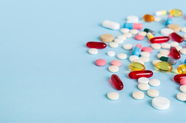 Many different colorful medication and pills perspective view Set of many pills on colored background