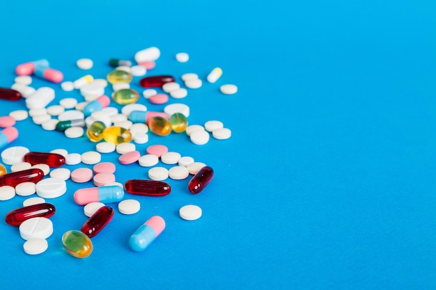 Many different colorful medication and pills perspective view Set of many pills on colored background