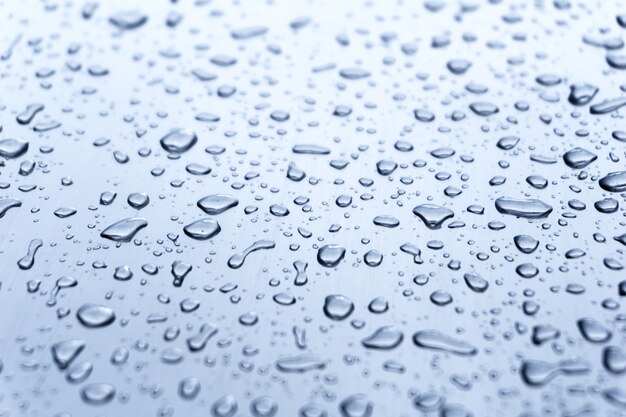 Many different drops of water on the metal surface