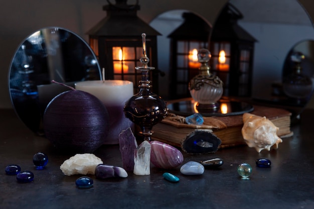 Photo many different gemstones on the blurred mirrors and  candles background.