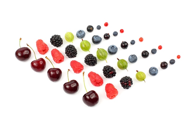 Many different juicy berries are arranged in order on a white background