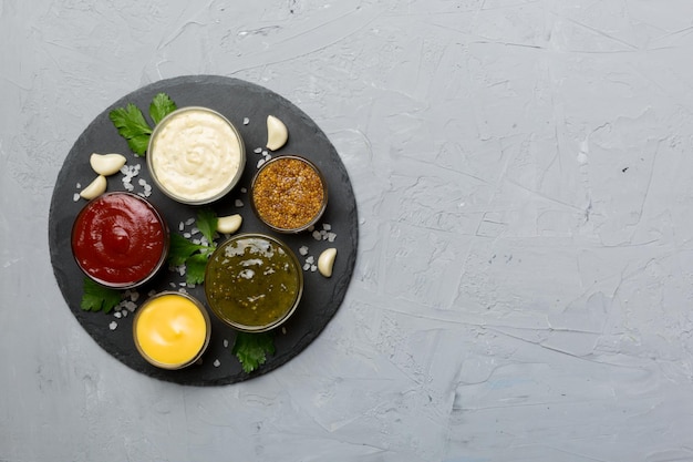 Many different sauces and herbs on table flat lay top view sauces on plate healthy concept