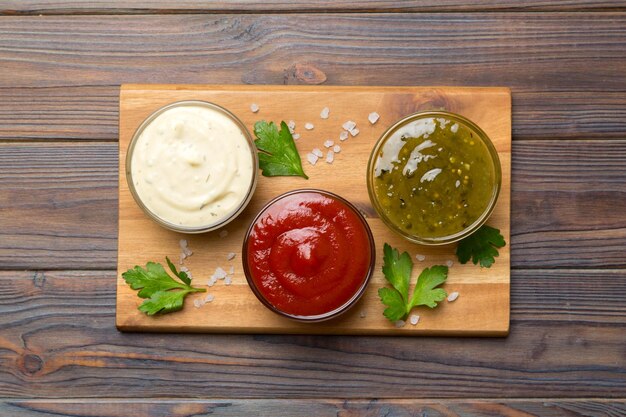 Many different sauces and herbs on table flat lay top view sauces on plate healthy concept