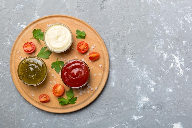 Many different sauces and herbs on table flat lay top view sauces on plate healthy concept