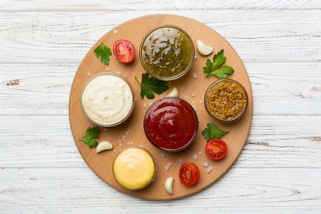 Many different sauces and herbs on table flat lay top view sauces on plate healthy concept