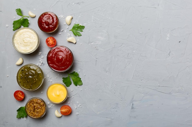 Many different sauces and herbs on table flat lay top view sauces with spices healthy concept