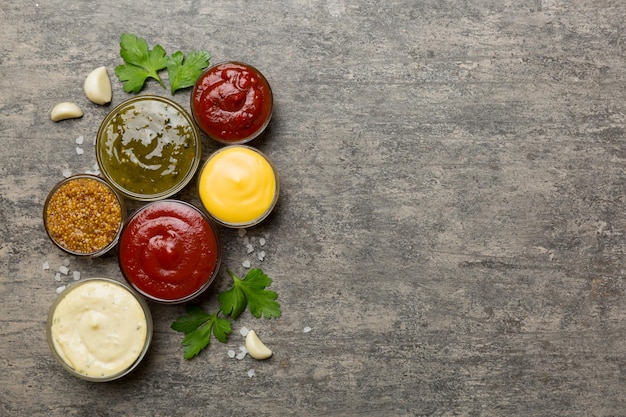 Many different sauces and herbs on table flat lay top view sauces with spices healthy concept