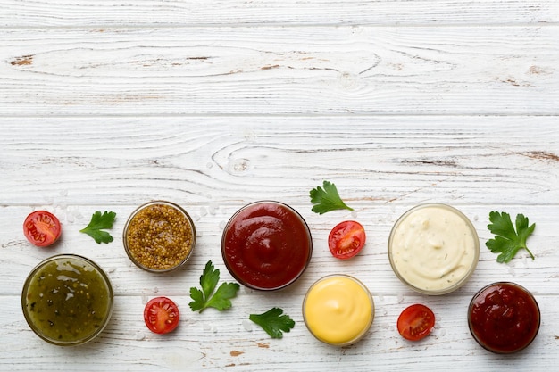 Many different sauces and herbs on table flat lay top view sauces with spices healthy concept