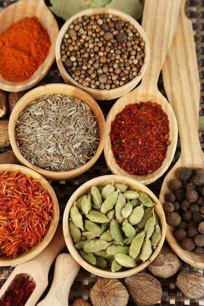 Many different spices and fragrant herbs on wooden table closeup