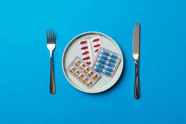 Many different weight loss pills and supplements as food on round plate Pills served as a healthy meal Drugs pharmacy medicine or medical healthycare concept