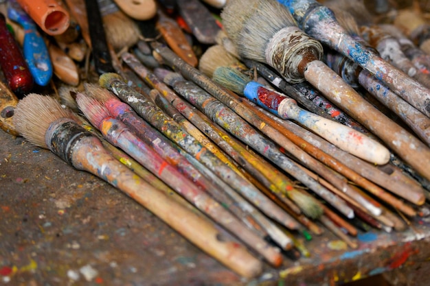 Many dirty brushes of the artist in the workshop