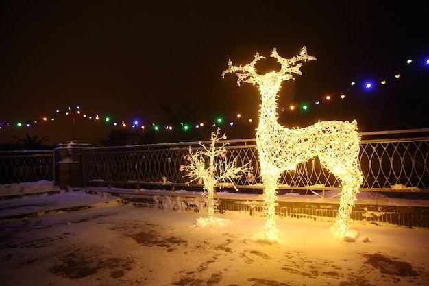 Many Festive Lights Lamps In Shape Deer In Evening Night Festive Illumination. Decorative Streets Elements In Christmas Xmas Holiday Season