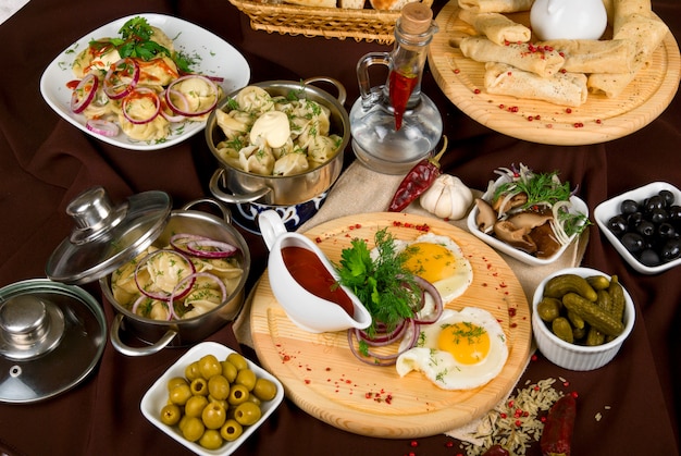 Many food dishes on the restaurant table. close up. 