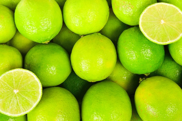 Many fresh limes on white background.