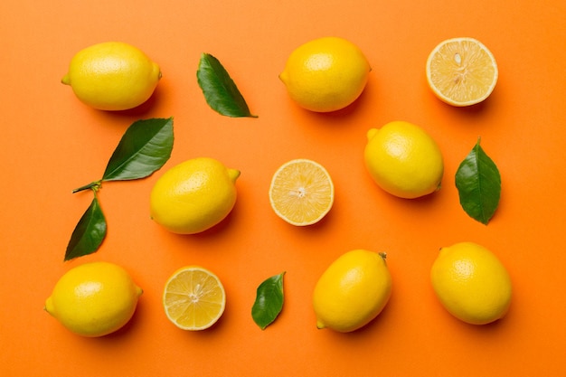 Many fresh ripe lemons as colored background top view Elegant background of lemon and lemon slices Top view flat lay