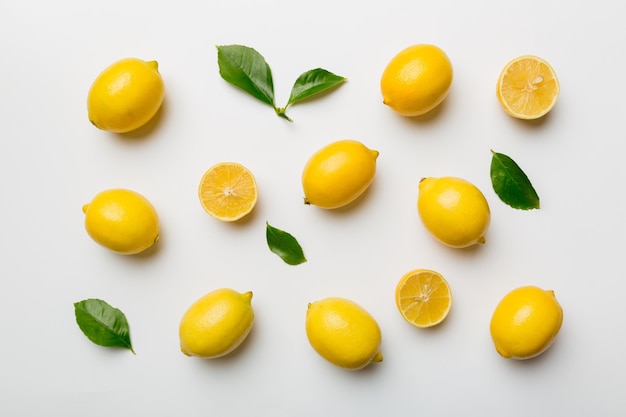 Many fresh ripe lemons as colored background top view Elegant background of lemon and lemon slices Top view flat lay