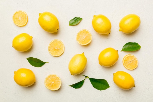 Many fresh ripe lemons as colored background top view Elegant background of lemon and lemon slices Top view flat lay