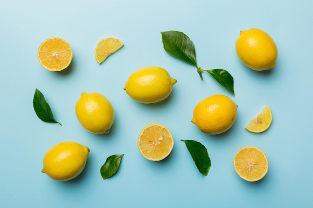 Many fresh ripe lemons as colored background top view Elegant background of lemon and lemon slices Top view flat lay