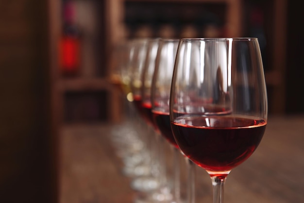 Many glasses of different wine in a row on bar counter