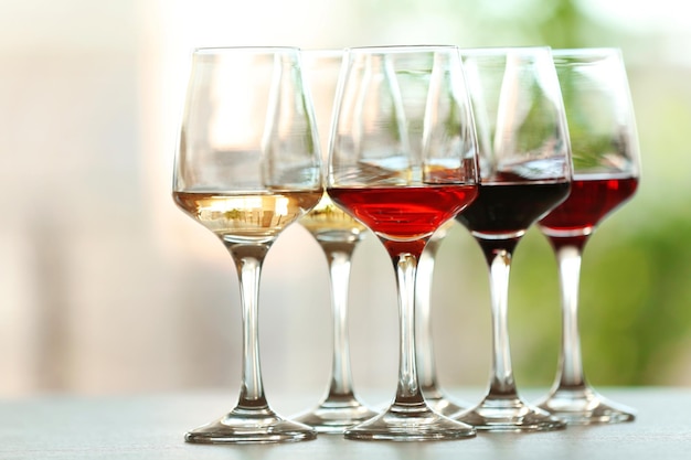 Many glasses of different wine on a table