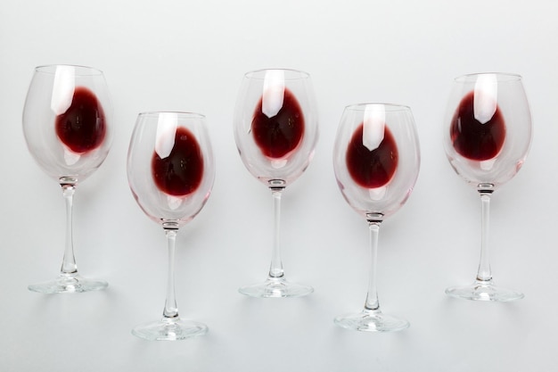 Many glasses of red wine at wine tasting. Concept of red wine on colored background. Top view, flat lay design.