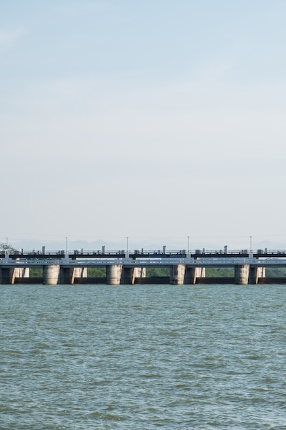 The many large gates of the service spillway on the reservoir dam, view from the lake backside the dam, front view with the copy space.