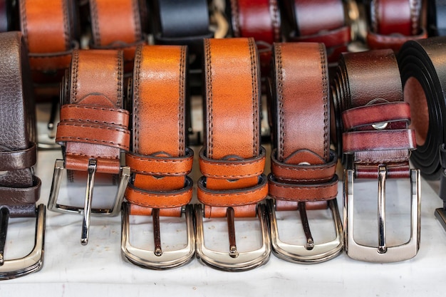 Many leather belts set on stall for sale in local street market in Thailand