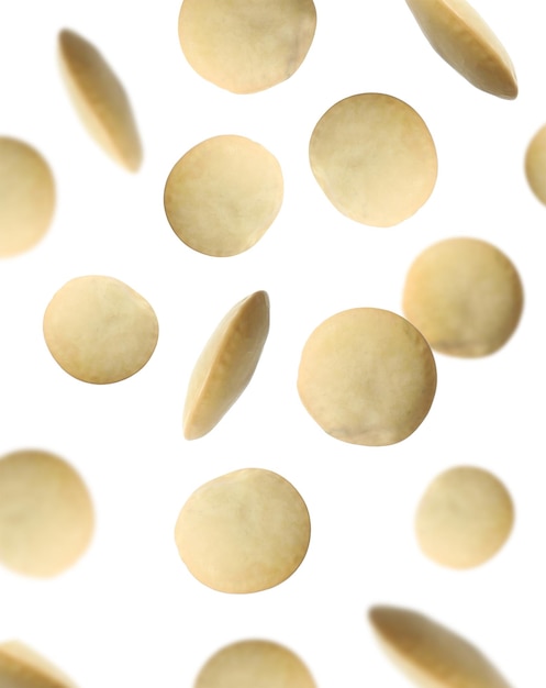 Many lentils falling on white background Vegan diet