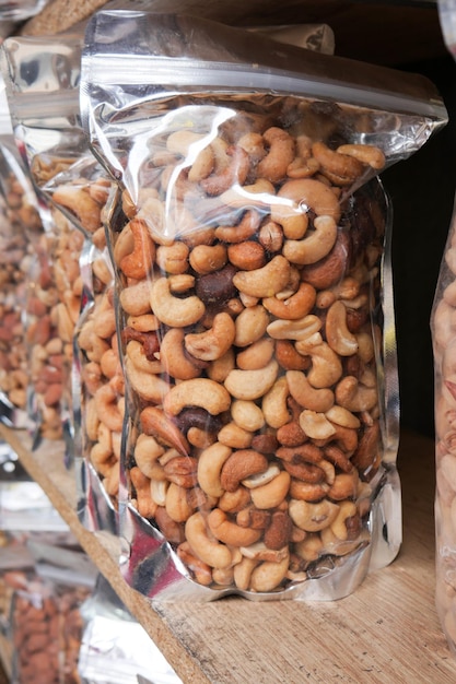 Many mixed nuts in a plastic packet on shelf