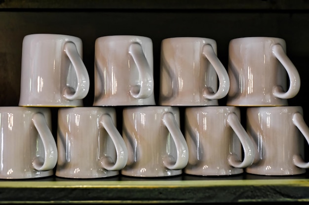 Many mugs in a row as decor for interior