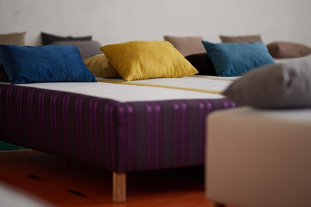 Many multicolored beds with pillows and linens in the interior of the gym